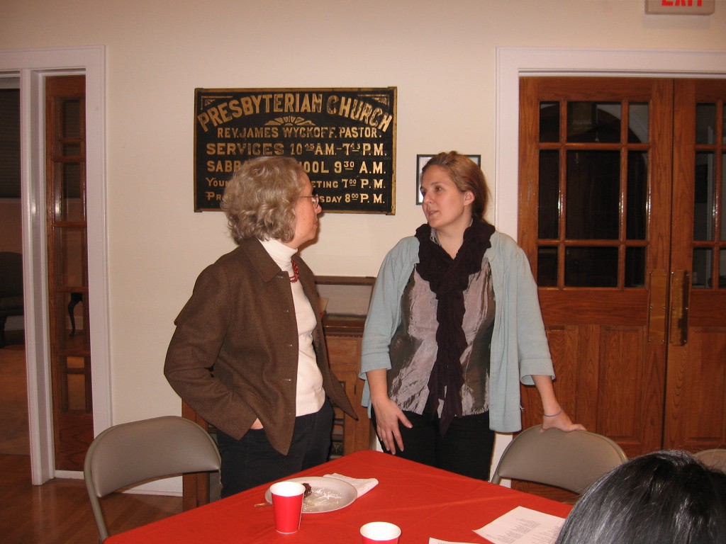 Reverend Givens and Vice-Chair Maria Andreu catch up